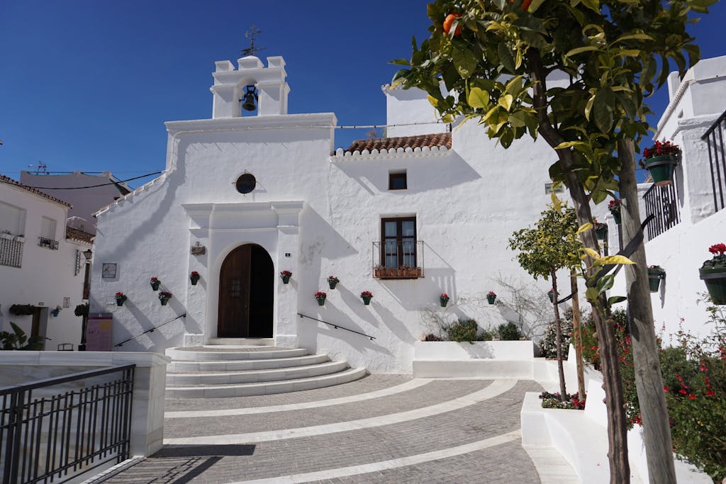 Beautiful white church facade in sunny Mijas, Spain, showcasing classic architecture.