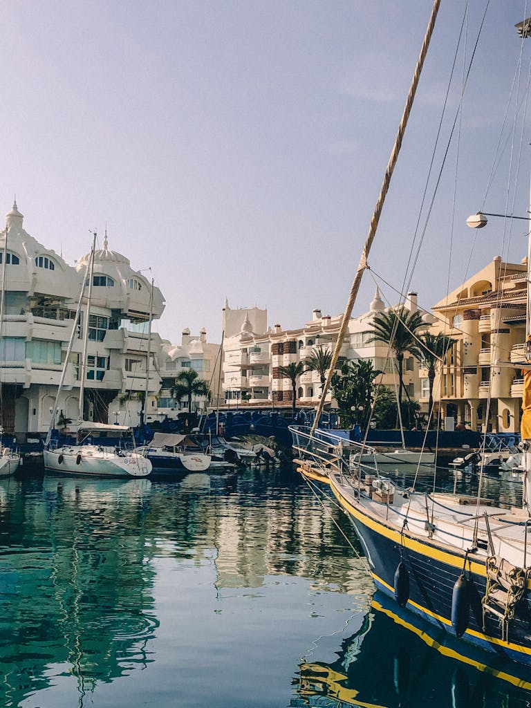 Picturesque marina in Benalmádena, Spain featuring moored yachts and Mediterranean architecture.